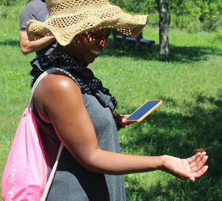 Monica Colvin of Ann Arbor watches a cicada on her finger.Matt Conzett/WDET