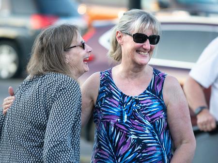 Clarinetists Cheryl Kopplin of Davisburg and Janelle Chopp of Tyrone Township laugh together after sharing a hug on June 10.  They said a lack of rehearsals and performances left a big emotional void in their lives.Tim Jagielo / WDET