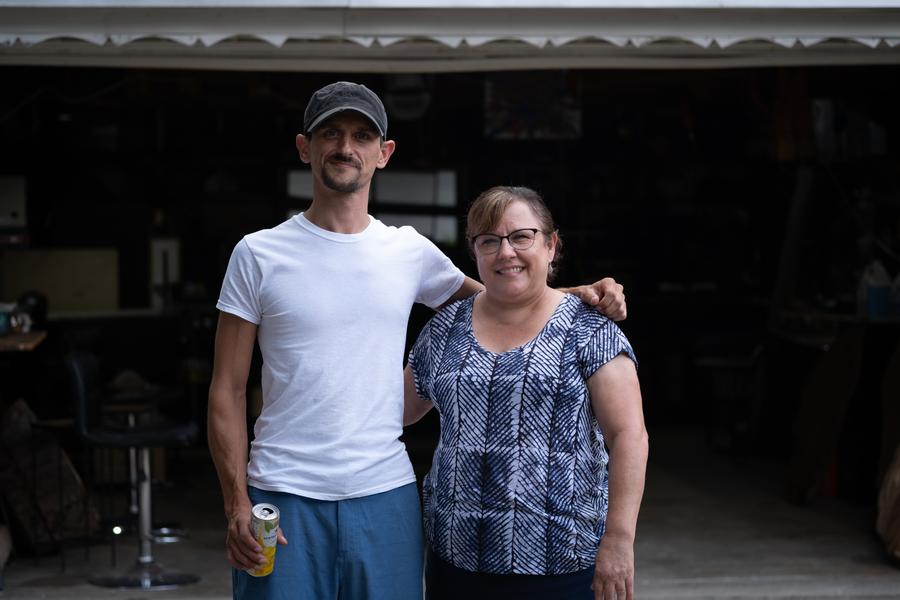 Daniel Michelsen and his neighbor Heather Adamcyzk pose for a photo in his garage-turned-studio in Dearborn.Erik Paul Howard