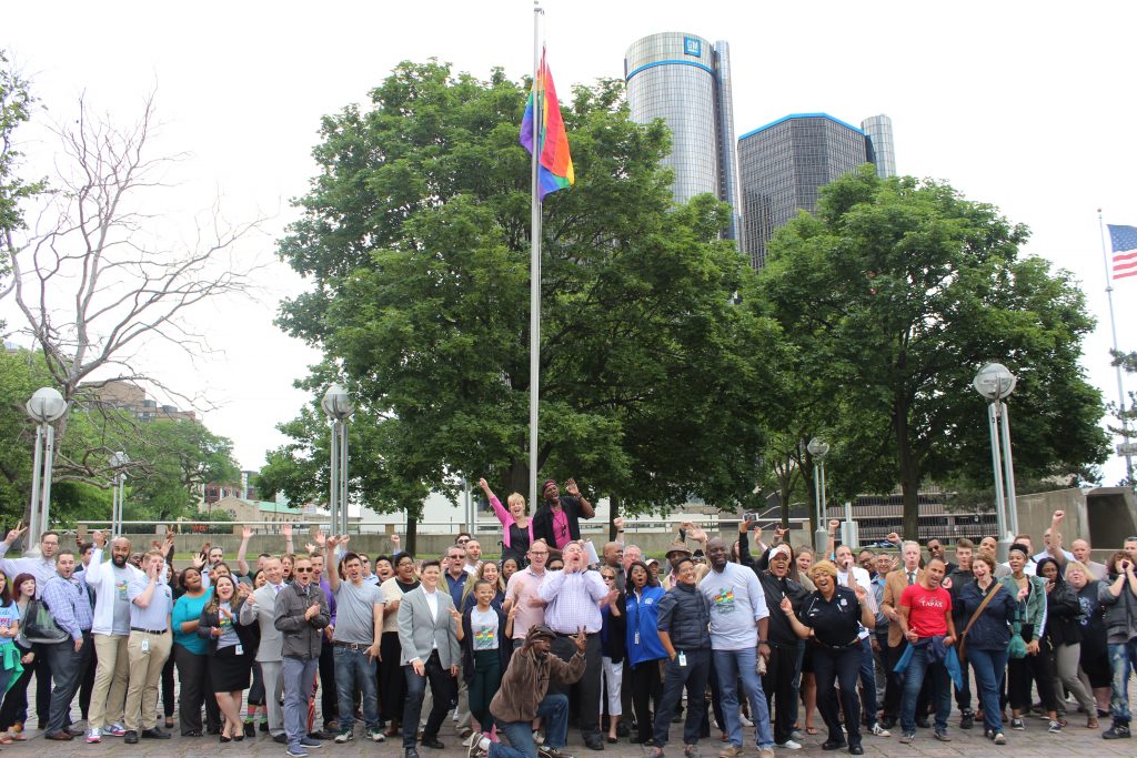 LGBT COmmunity Raising Rainbow Flag