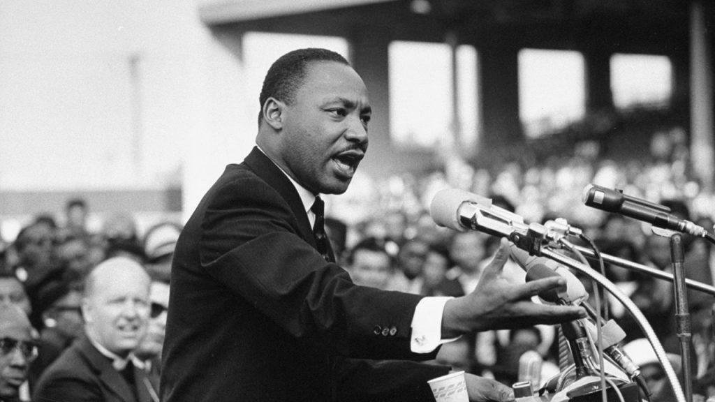 black and white image of martin luther king jr addressing a crowd