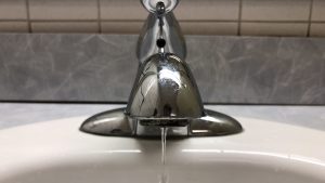 Photo of water dripping from a faucet.