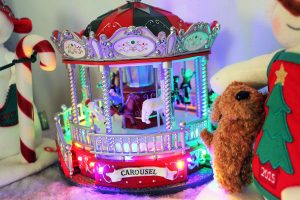 a small carousel figurine with multi-colored lights