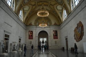 A room in the DIA with marble floors, stone walls, high decorated ceilings and chandeliers