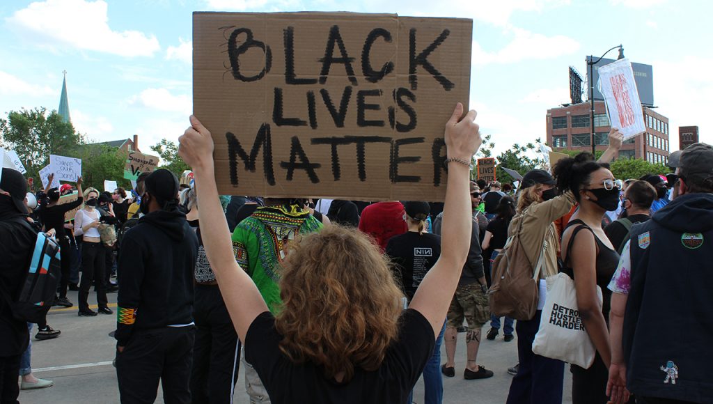 A person holds up a "Black Lives Matter" sign during a protest in Detroit, Mich.