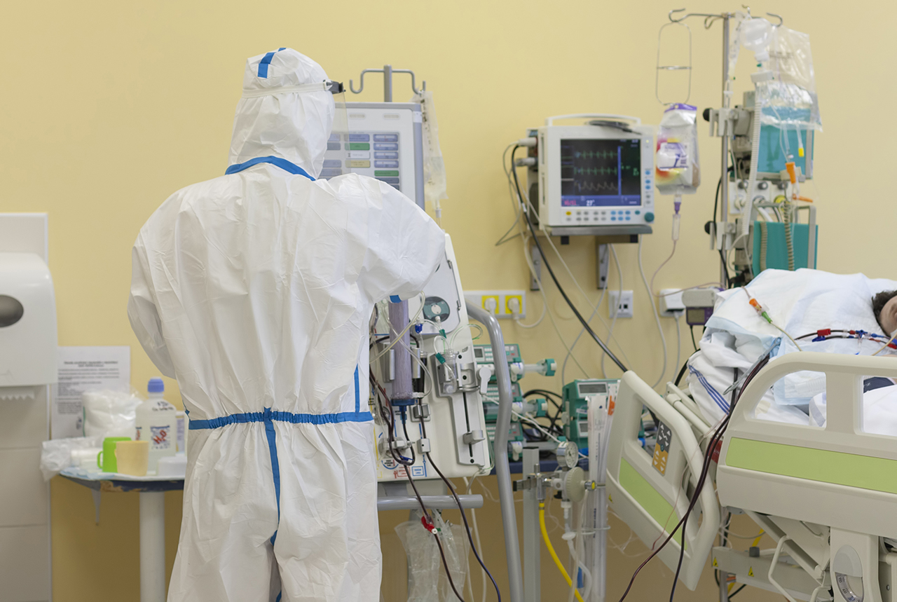 Nurse with protective coverall clothing in intensive care unit