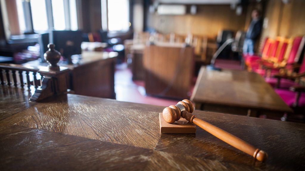 Color image of a hammer in a courtroom.