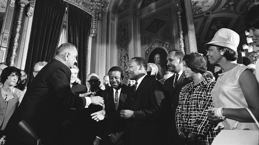 President Lyndon Johnson greets Dr. Martin Luther King, Jr., at the signing of the Voting Rights Act of 1965.
