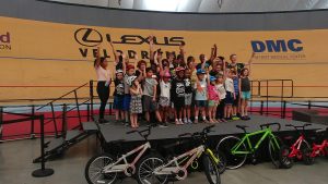 A group of kids pose for a celebratory photo at the Lexus Velodrome.