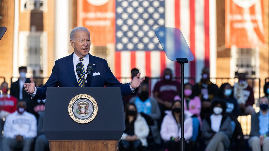 Joe Biden stands at a podium addressing a crowd