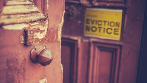 Stock photo of eviction notice posted on a door.