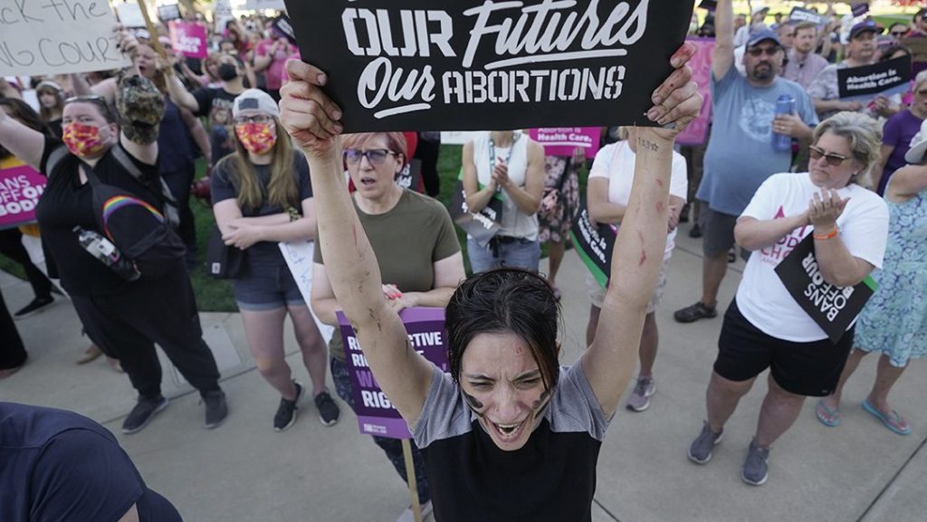 Abortion rights supporters hold signs at a demonstration