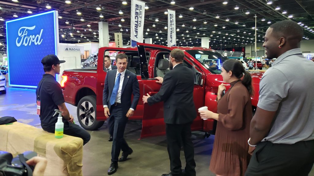 Pete Buttigieg steps out of a Ford F-150 Lightning.