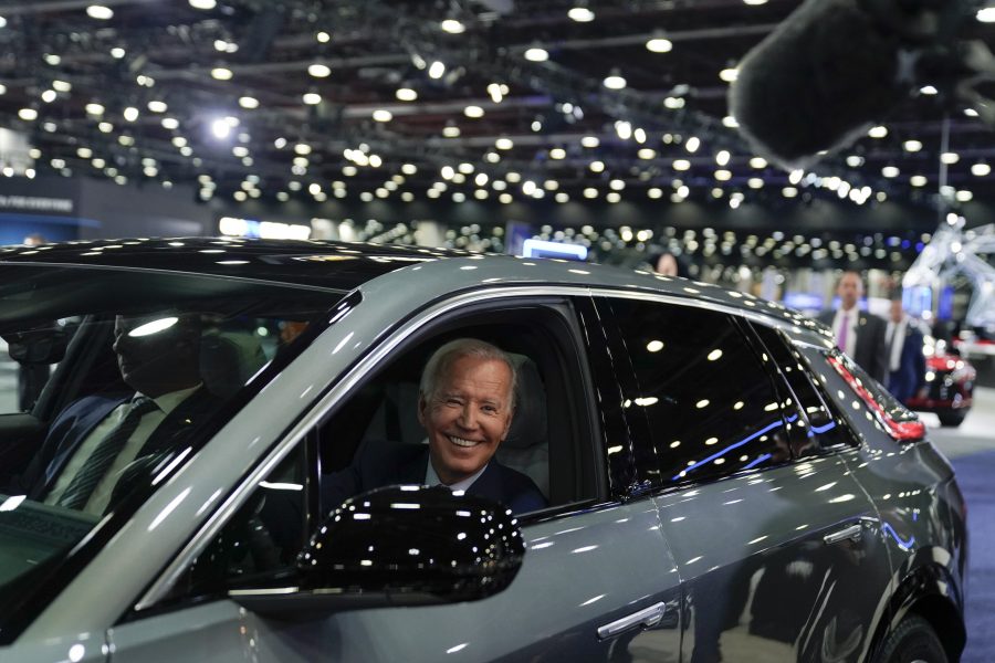 President Joe Biden drives a Cadillac Lyriq through the show room during a tour at the Detroit Auto Show, Wednesday, Sept. 14, 2022, in Detroit.