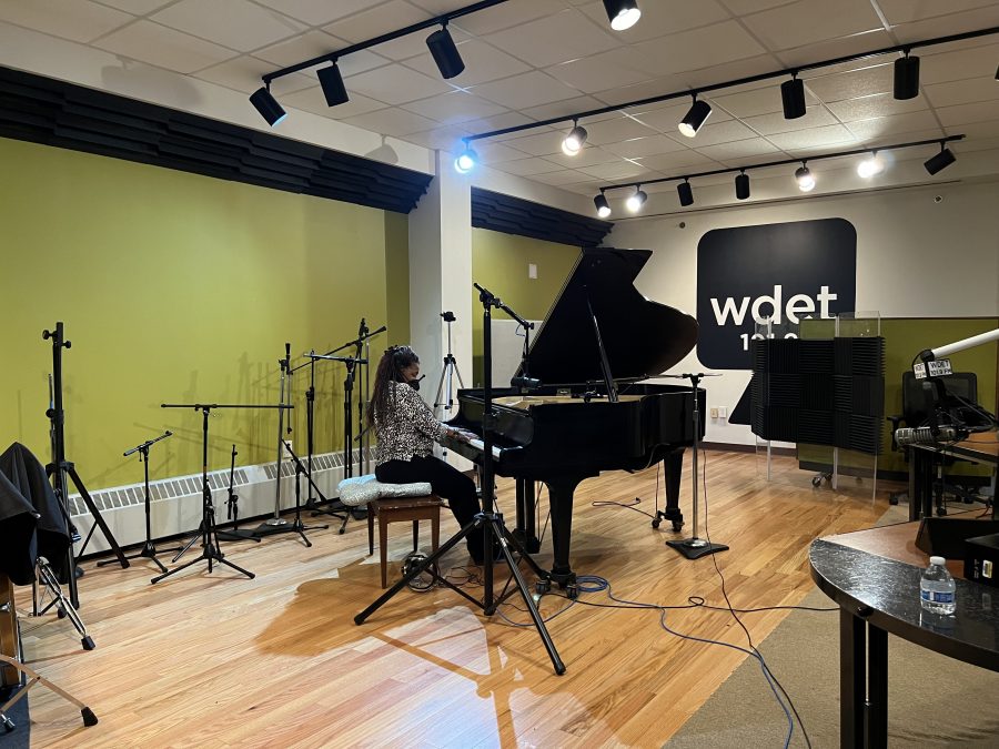 a woman plays a piano in the WDET studio