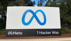 entrance sign to the Meta headquarters with a blue logo