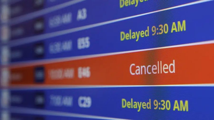 A video board shows flight delays and cancellations at Ronald Reagan Washington National Airport in Arlington, Va., Wednesday, Jan. 11, 2023.