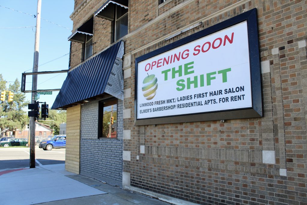 exterior of a brick building with a sign that reads, "Opening soon: The Shift, including Linwood Fresh Market"