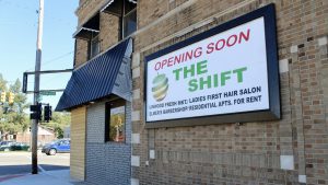 exterior of a brick building with a sign that reads, "Opening soon: The Shift, including Linwood Fresh Market"
