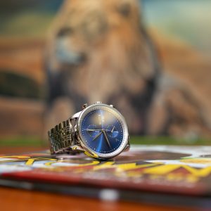 silver watch with a deep blue face