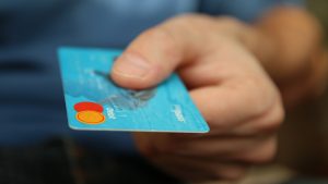 Person holding debit card.