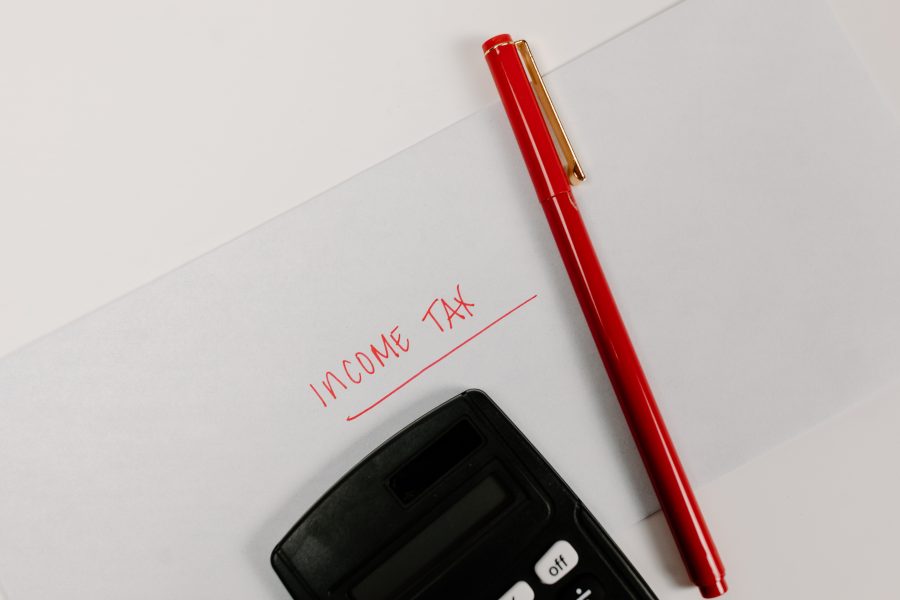Stock photo of calculator, pen and envelope that says income tax.