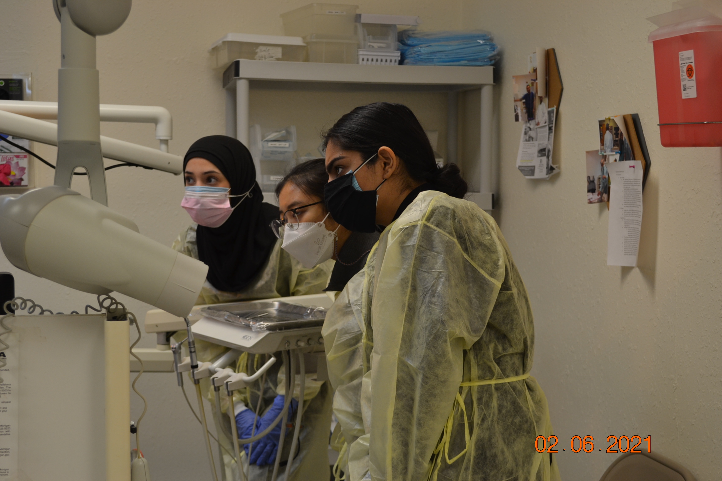 Dental students providing care for a patient at the HUDA Clinic.