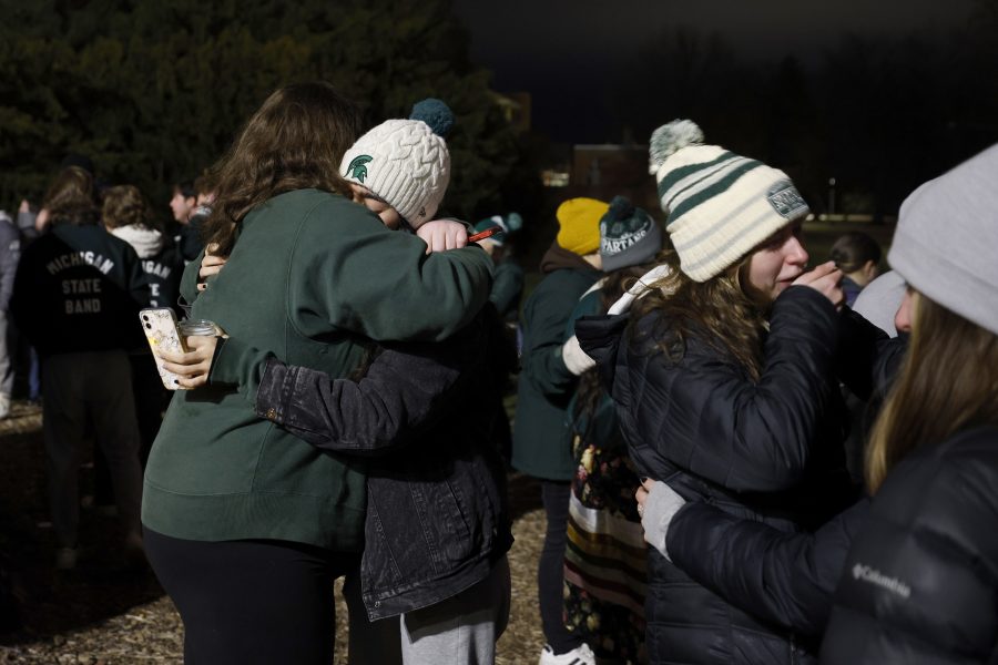 Mourners attend a vigil at The Rock on the grounds of Michigan State University in East Lansing, Mich., Wednesday, Feb. 15, 2023. Alexandria Verner, Brian Fraser and Arielle Anderson were killed and several other students remain in critical condition after a gunman opened fire on the campus of Michigan State University Monday night. (AP Photo/Al Goldis)