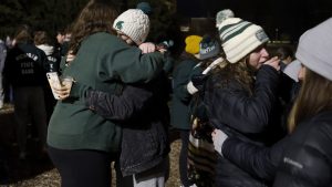 Mourners attend a vigil at The Rock on the grounds of Michigan State University in East Lansing, Mich., Wednesday, Feb. 15, 2023. Alexandria Verner, Brian Fraser and Arielle Anderson were killed and several other students remain in critical condition after a gunman opened fire on the campus of Michigan State University Monday night. (AP Photo/Al Goldis)