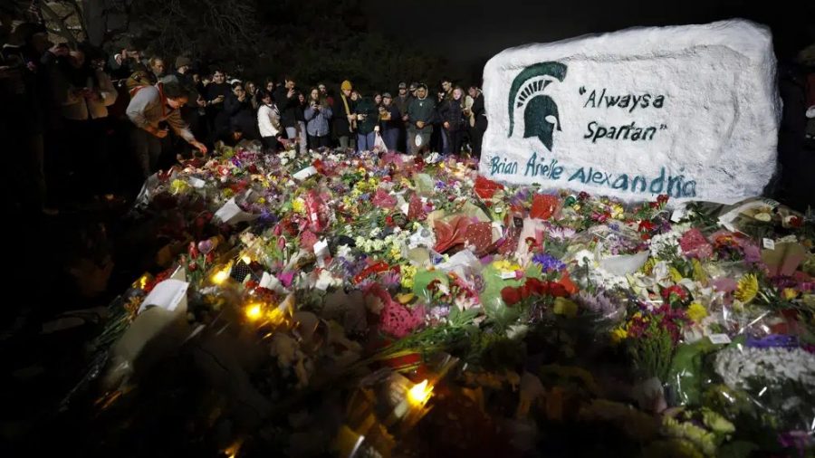 Mourners attend a vigil at The Rock on the grounds of Michigan State University in East Lansing, Mich., Wednesday, Feb. 15, 2023.
