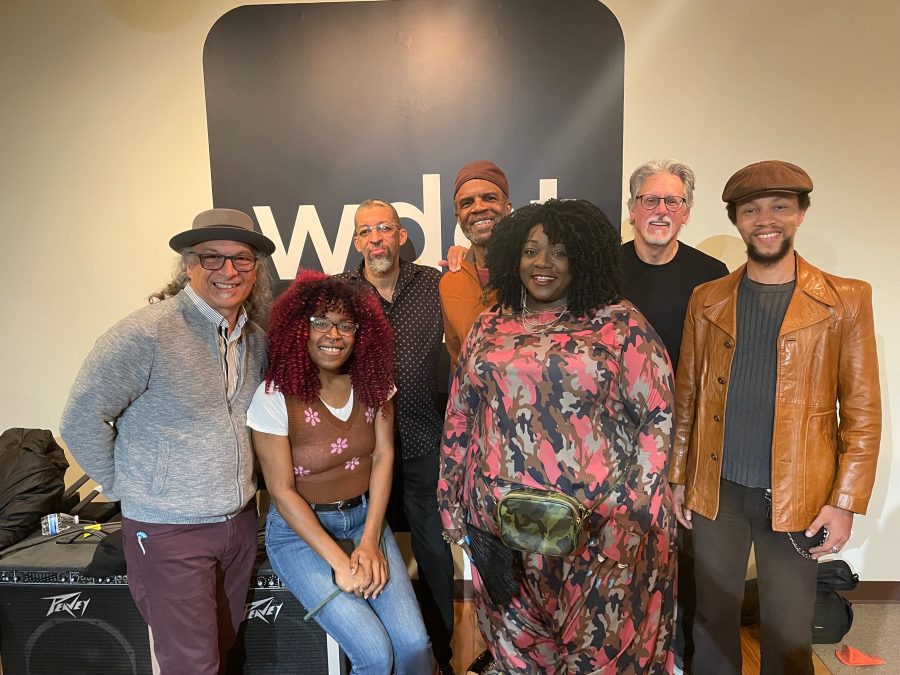 Thornetta Davis and her five backing musicians smile with Tia Graham in WDET's live studio