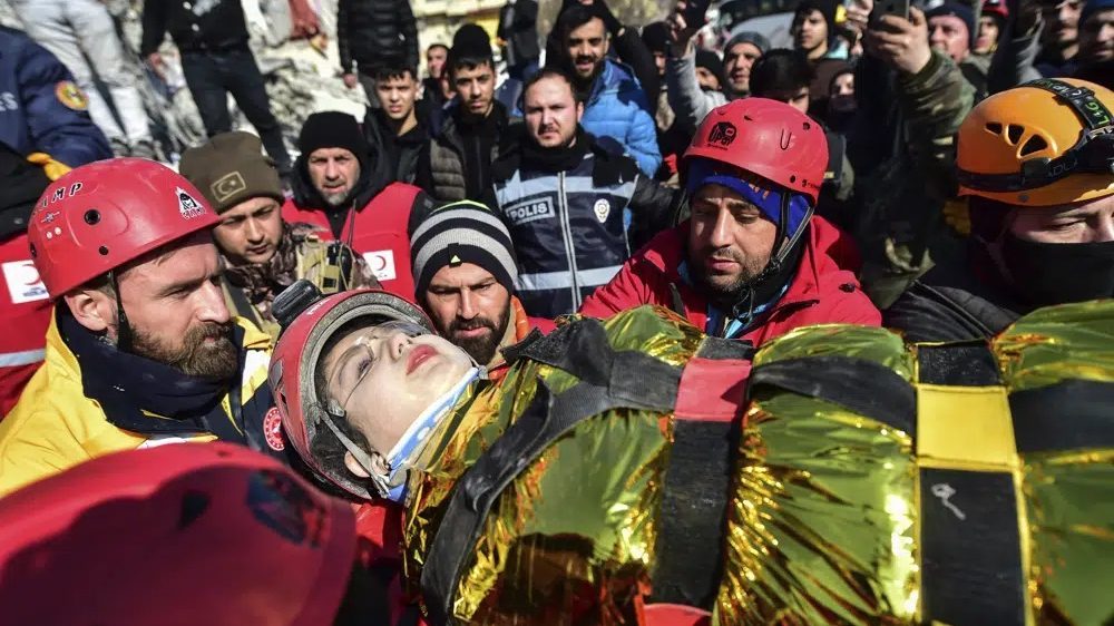 Rescuers carry Zeynep Polat, pulled out from a collapsed building days after the earthquake, in Kahramanmaras, southern Turkey, Thursday, Feb. 9, 2023.