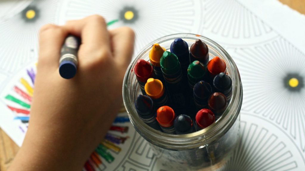 Stock photo of child using crayons.