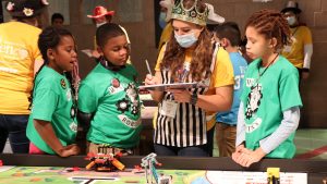 Children compete at FIRST robotics competition.