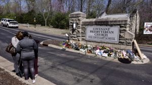 A group of women pray at a memorial at the entrance to The Covenant School on Wednesday, March 29, 2023, in Nashville, Tenn.