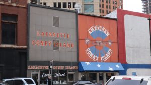 exteriors of two restaurants, one decorated in gray and red that reads "Lafayette Coney Island," the other decorated in red, white and blue that reads "American Coney Island" with a blue and white starred awning