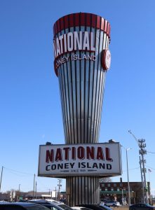 A large silver and red metallic cone reads "National Coney Island"