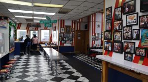 Interior of American Coney Island, with black and white checkered floors and red white and blue decor.