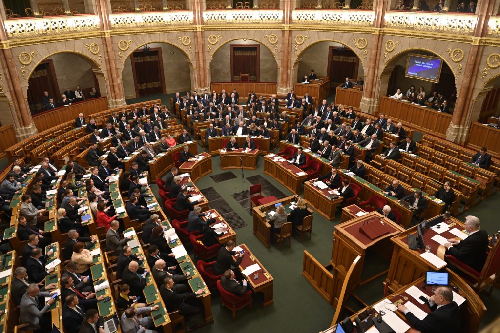 Hungary's Prime Minister Viktor Orban votes along with lawmakers next to deputy premier Zsolt Semjen, on Finland's bid to join NATO, at the parliament in Budapest, Hungary, Monday, March 27, 2023.