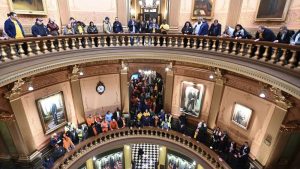 FILE - Union members and supporters chant in the Capitol rotunda, Tuesday morning, March 14, 2023, as they wait for a Right To Work bill to be voted on.