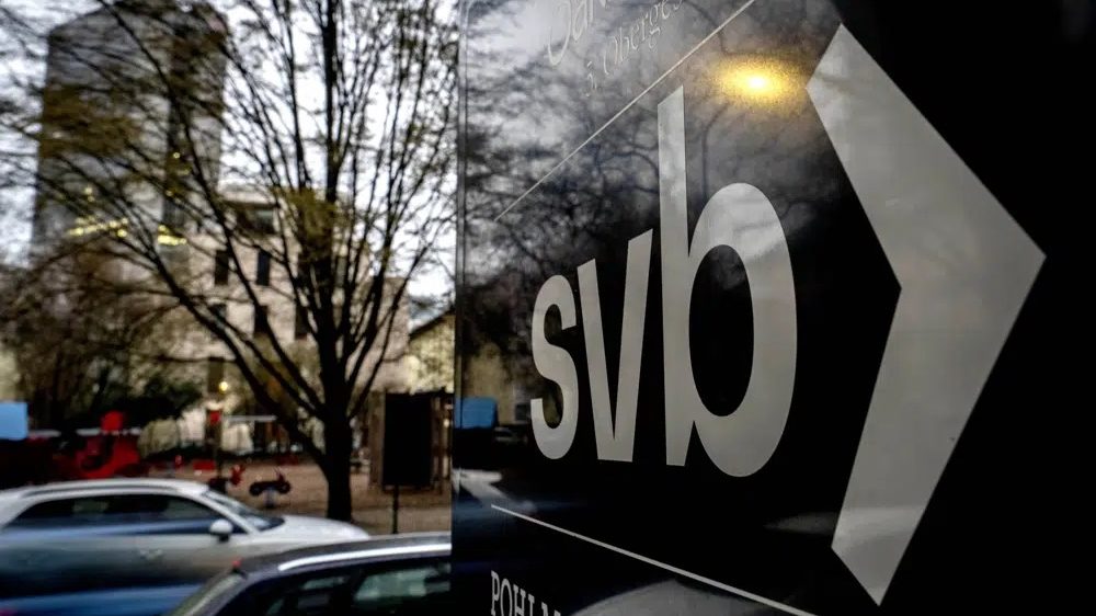A sign of a branch of the Silicon Valley Bank is pictured at an office building where the bank is located in Frankfurt, Germany, Monday, March 13, 2023. (AP Photo/Michael Probst)