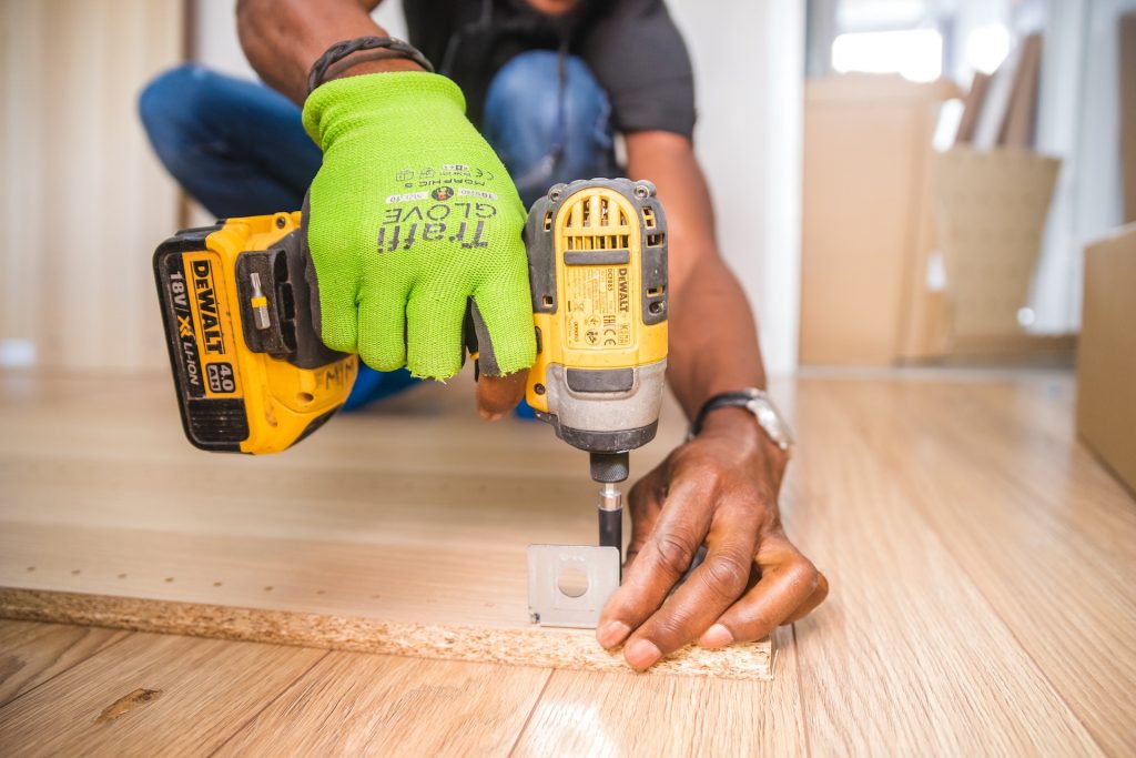 Stock photo of a contractor installing flooring.