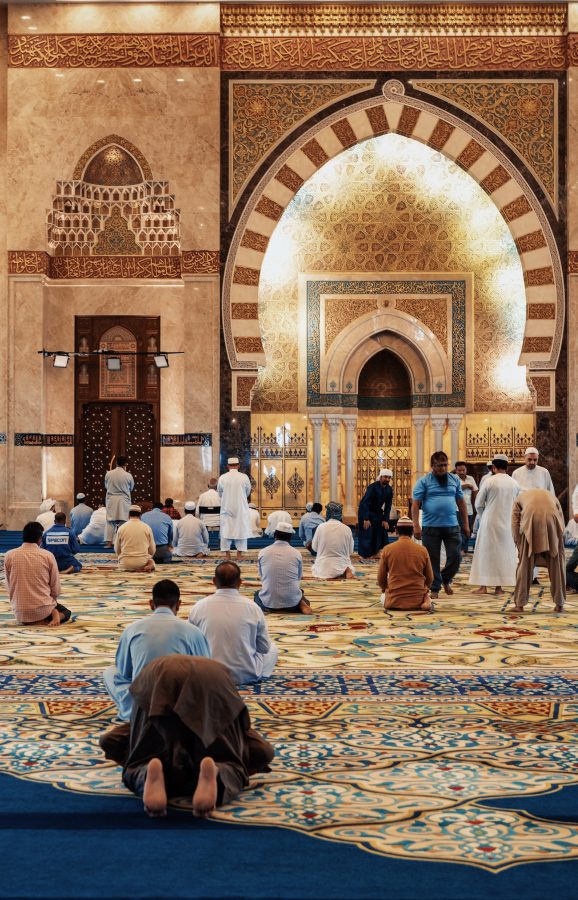 Muslim men kneel in prayer in a mosque