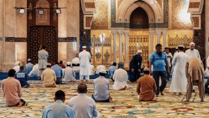 Muslim men kneel in prayer in a mosque