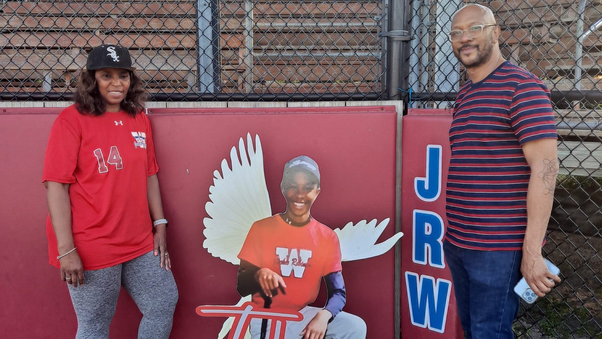 Melanie White (left) and Darren Pollard with a cutout picture of their son at a baseball field in Chicago.