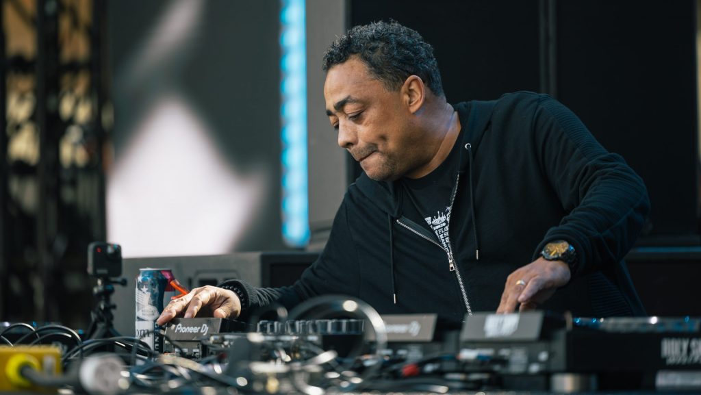 Electronic musician Delano Smith works a turntable onstage at Movement 2022.