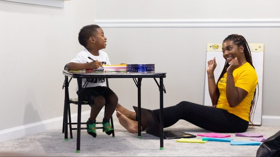 Black mom and child doing school work together