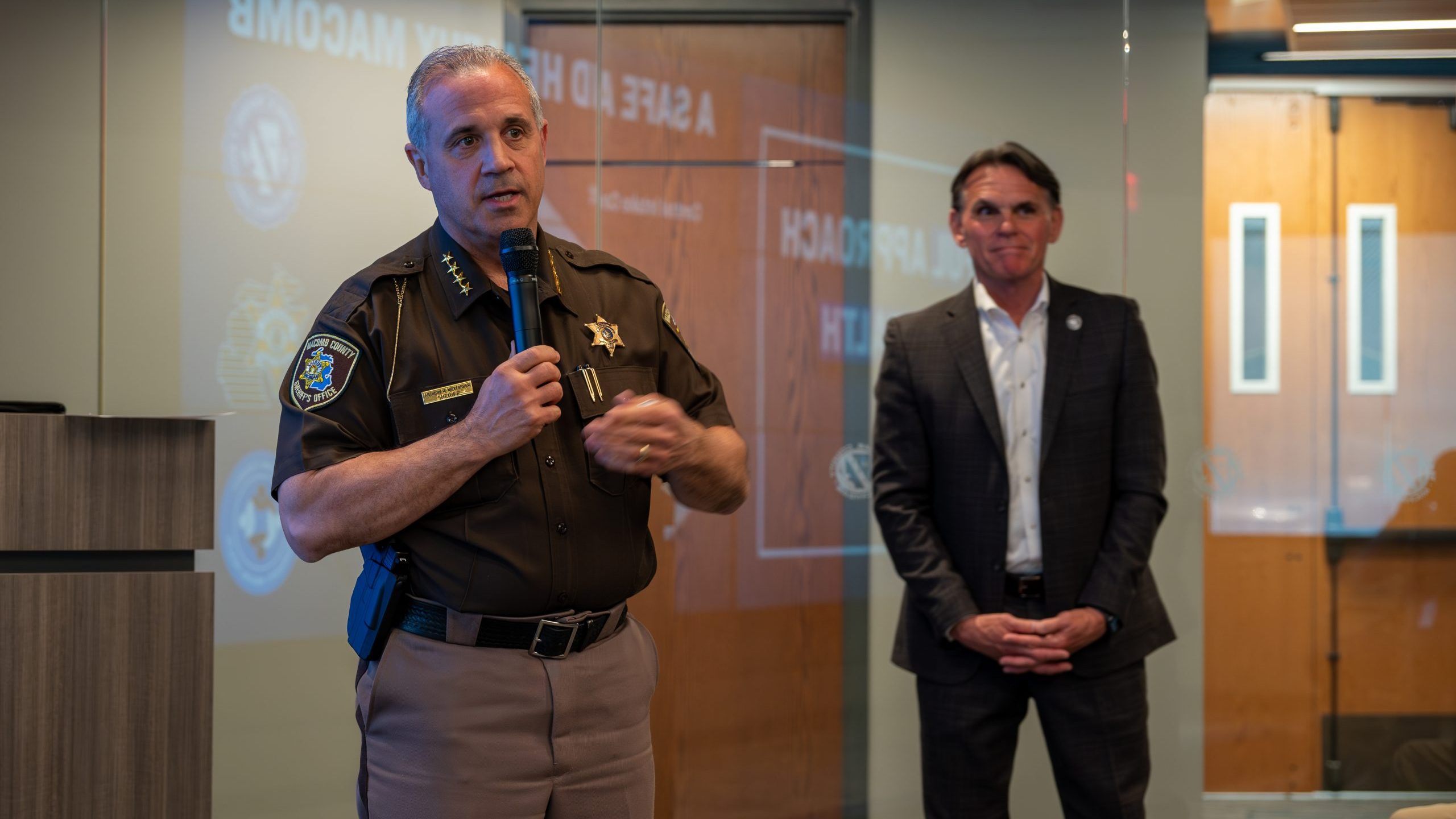 Macomb County Sheriff Anthony Wickersham discusses plans for renovating the county jail on May 12, 2023, as county executive Mark Hackel looks on.