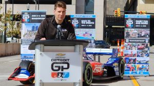 IndyCar Series champion Will Power stands at the podium of a Detroit Grand Prix press conference