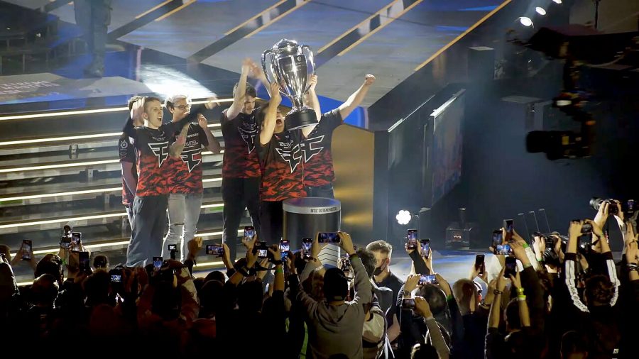 A group of young men wearing FaZe jerseys accepting a trophy at an awards show